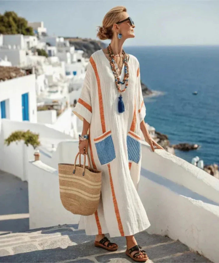 White maxi summer dress with orange stripe trim and blue stripe pocket panels