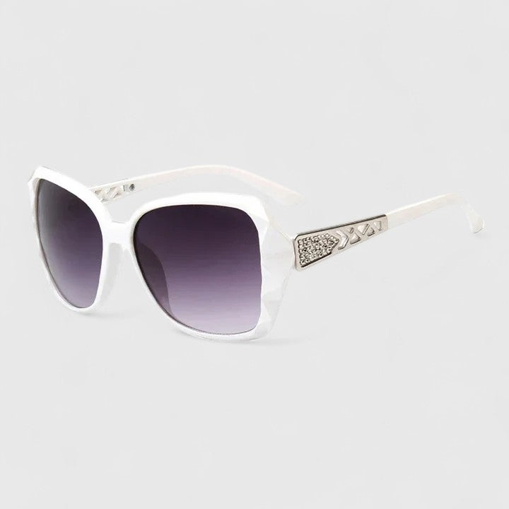 Sophisticated sunglasses, white frame with purple gradient lenses and rhinestone temple bar.
