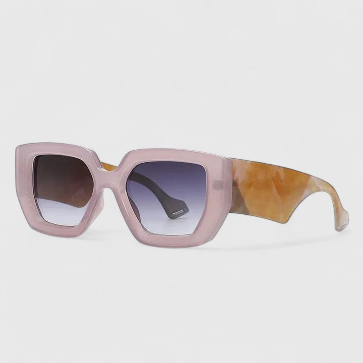 Pink oversized square sunglasses with dark purple tinted lenses and patterned temple arm