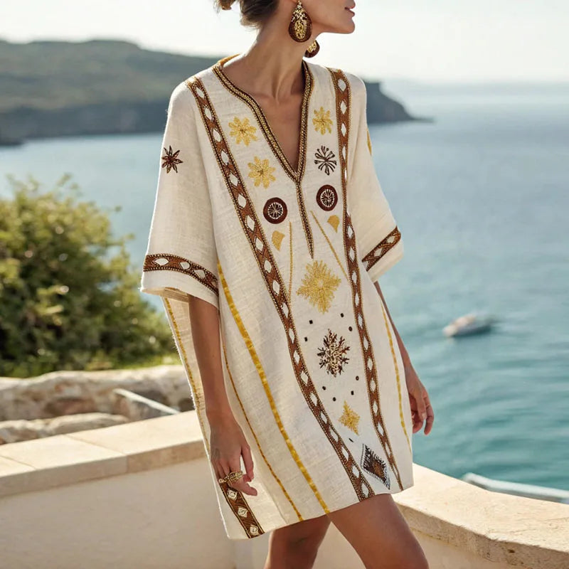 Vera beach dress with V-neck, short sleeves, yellow and brown patterned fabric