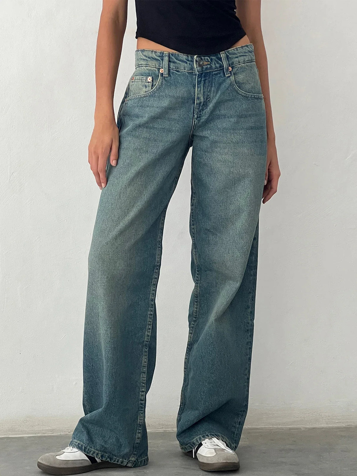 Teal-blue washed baggy jeans with high-rise waistband, button fly, and relaxed wide leg.