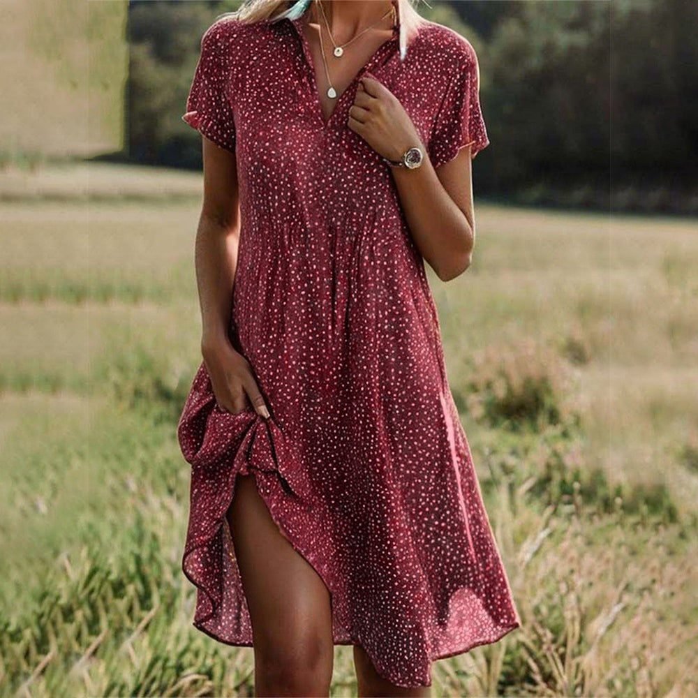 Red flowy dress with white speckle print, V-neck, short sleeves, side slit