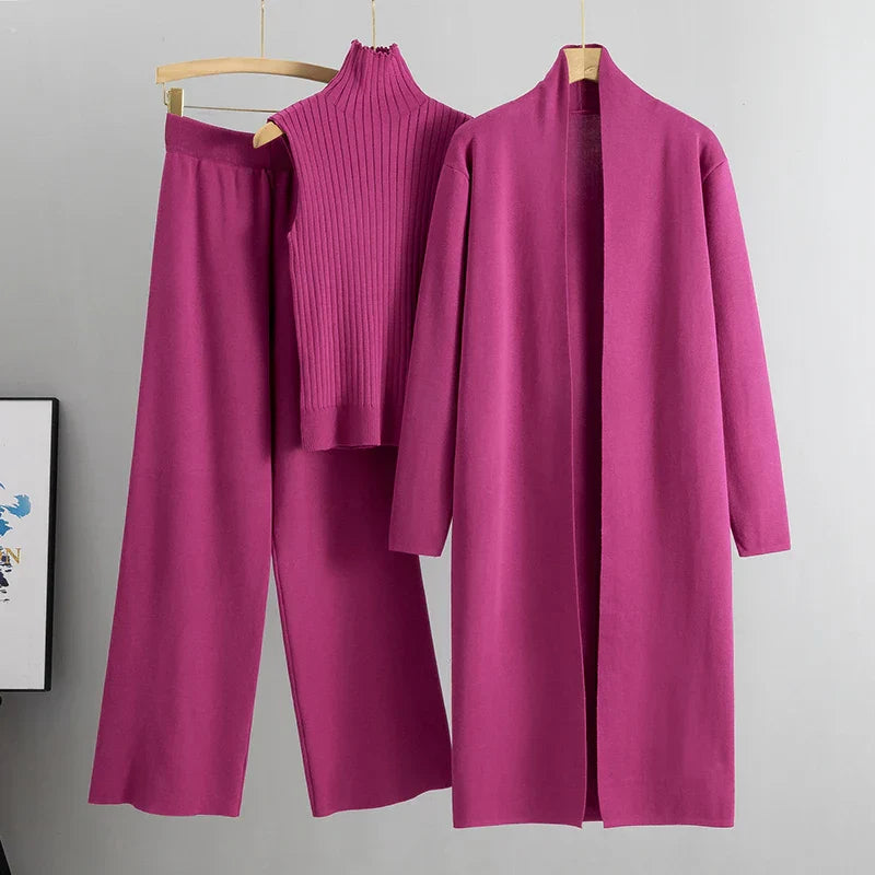 Pink three-piece set: ribbed sleeveless turtleneck top, wide-leg pants, long cardigan