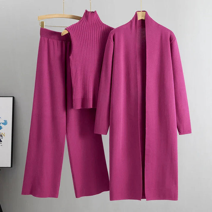Pink three-piece set: ribbed sleeveless turtleneck top, wide-leg pants, long cardigan