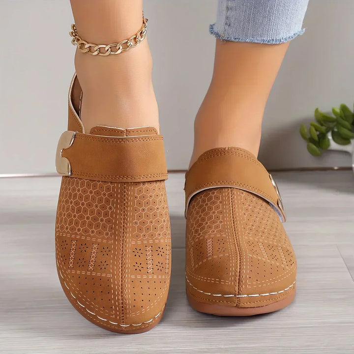 Light brown perforated wedge sandals with side strap and gold-tone buckle