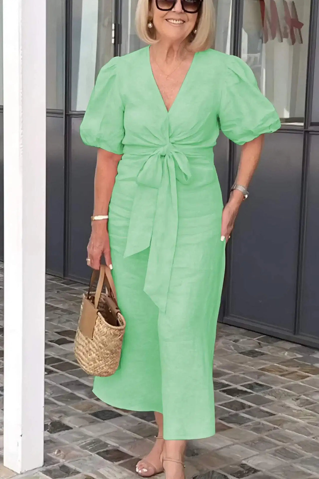 Light green V-neck midi dress with puff sleeves and waist tie, front view