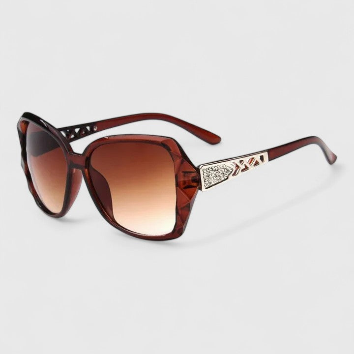 Red-brown framed sunglasses with gradient lenses and rhinestone-accented temple bar