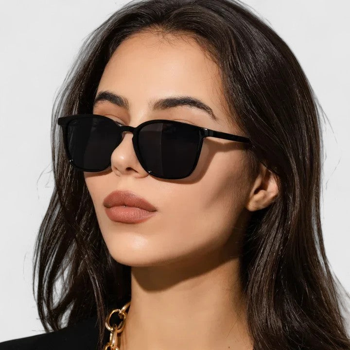 Sophisticated sunglasses, black rounded-square frame with dark lenses