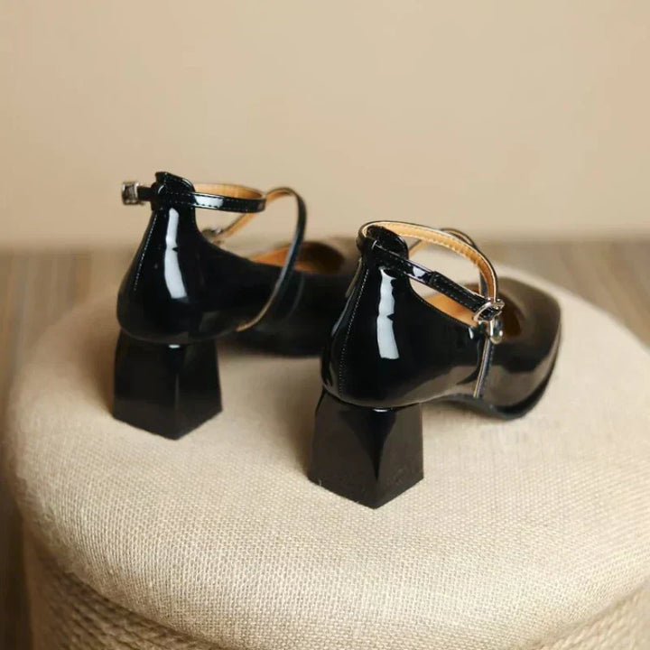 Black ankle-strap pumps with T-strap slingback and block heel, glossy leather