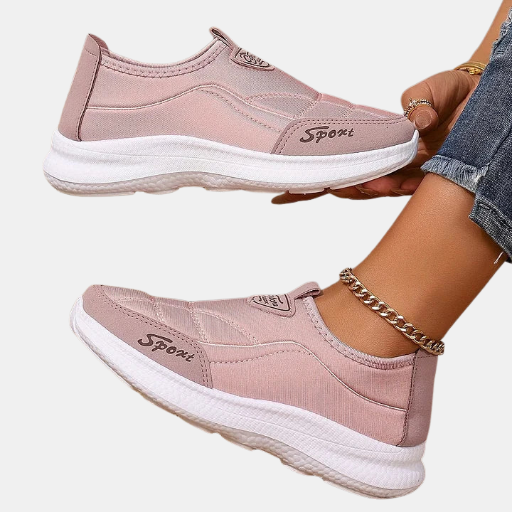 Pink slip-on sneakers with gold chain ankle detail and white midsole
