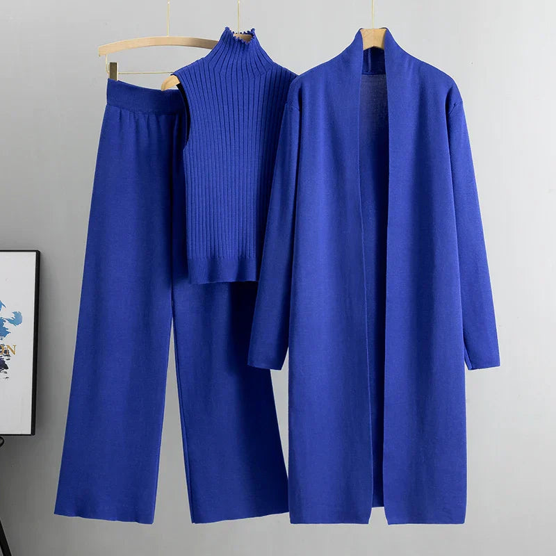 Blue three-piece set: ribbed sleeveless turtleneck top, wide-leg pants, long cardigan