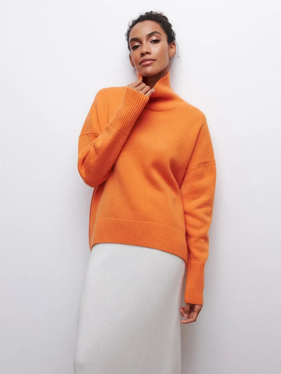 Orange turtleneck sweater with ribbed cuffs and hem