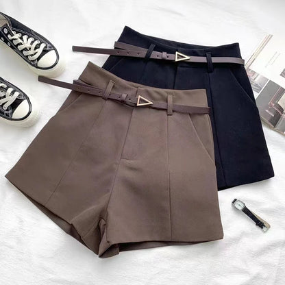 Taupe and navy high-waist shorts with front crease and faux leather belts with gold buckle