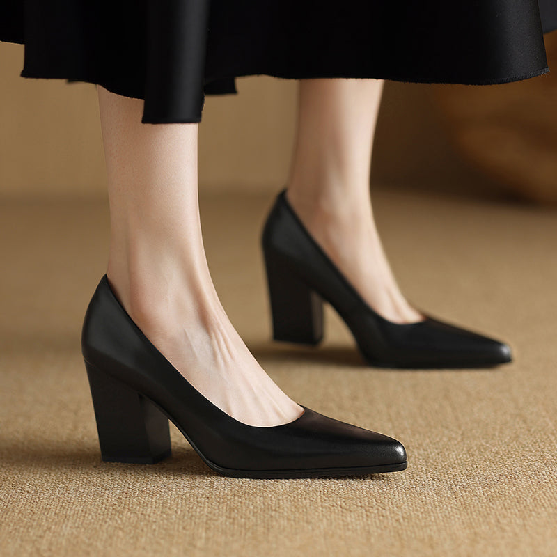 Black pointed-toe pumps with square block heel, front side view