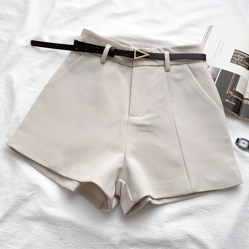 Ivory high-waist shorts with front crease and faux leather belt with gold buckle