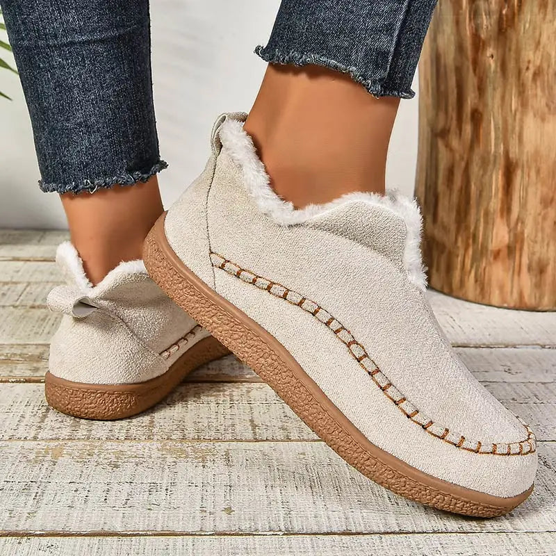 Beige orthopedic slip-on slippers, side view with plush collar and brown sole