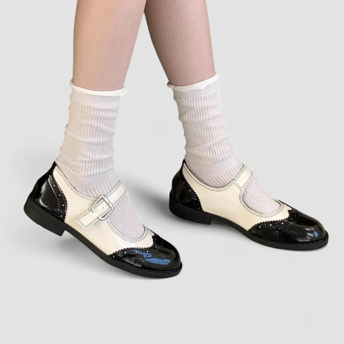 Cream and black Mary Jane shoes with buckle strap and glossy toe cap