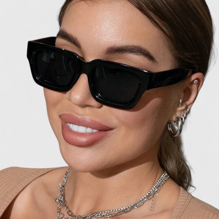 Black sunglasses with dark lenses on face, square frame style