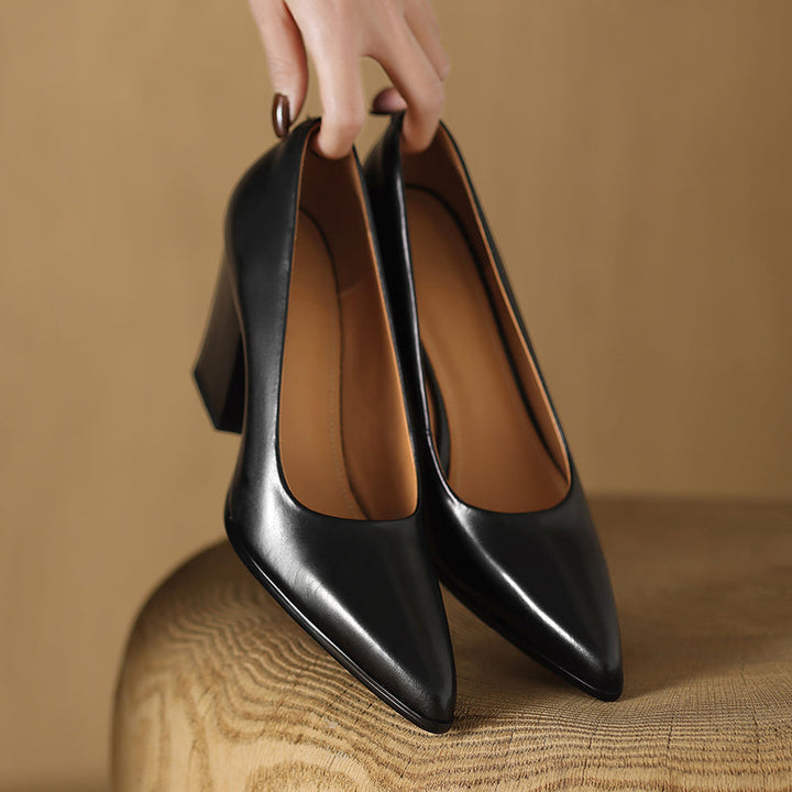 Black pointed-toe pumps with smooth upper, close pair view