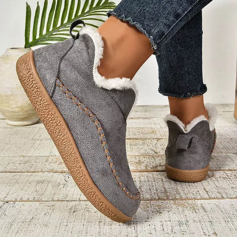 Gray orthopedic slip-on slippers with plush lining and stitched center panel