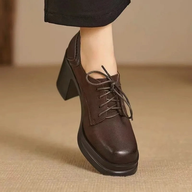 Brown lace-up ankle pumps with mid-height block heel and thick sole