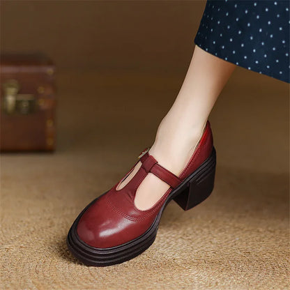 Red chunky Mary Jane pumps with cutout upper, buckle strap, stacked black heel