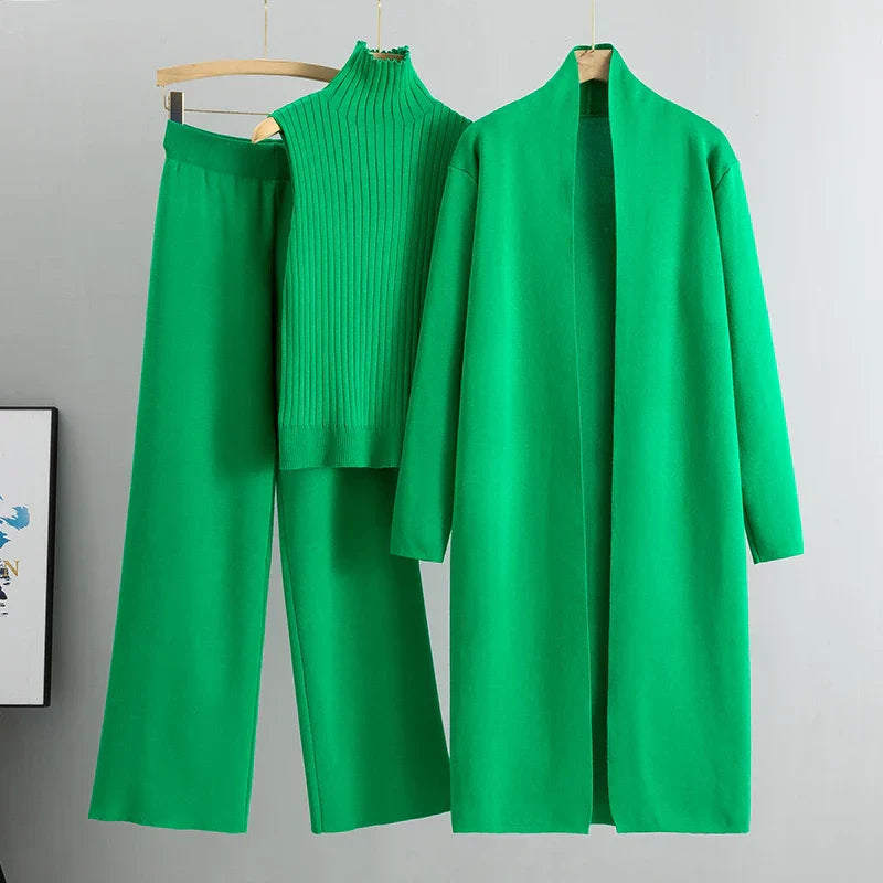 Green three-piece set: ribbed sleeveless turtleneck top, wide-leg pants, long cardigan