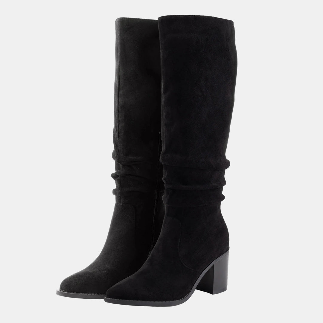 Black suede knee-high boots with ruched cuff, side zip, and block heel