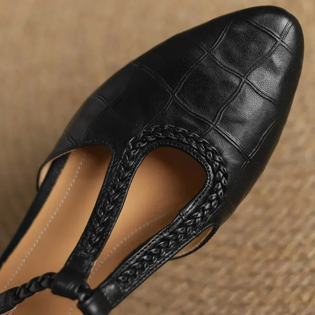 Black leather Mary Jane shoe with braided trim and open oval toe cutout