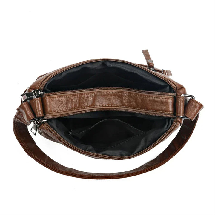 Brown leather multi-layer crossbody bag interior view with open top and inner zip pocket