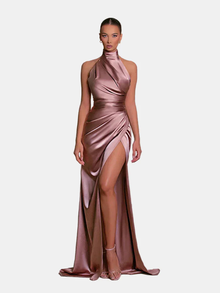 Pink satin side-slit maxi dress, halter neck, sleeveless with draped wrap front.