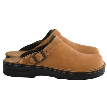 Tan leather slip-on clogs with buckle strap and cushioned black outsole