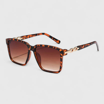 Square animal-print sunglasses with brown gradient lenses and gold chain bar detail