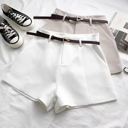 White high-waist shorts with front crease and matching belt with gold buckle