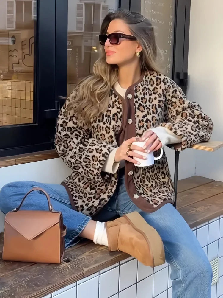 Leopard print cardigan with button front and long sleeves, worn open at the neck