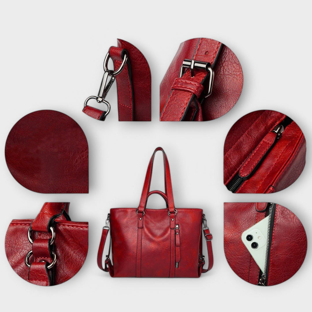Red leather large bag with top handles, crossbody strap, and zip details.