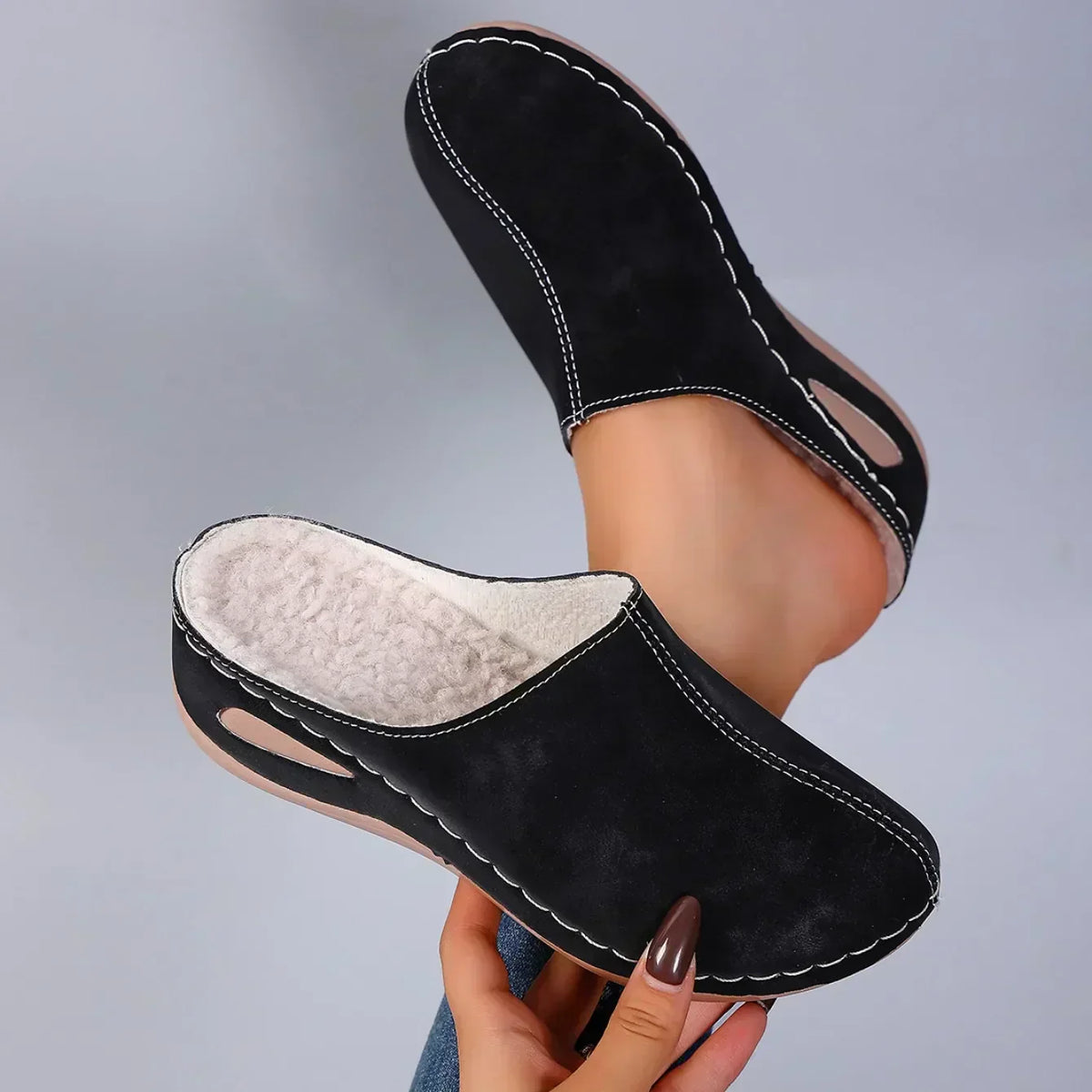 Black orthopedic slip-on slippers with beige lining, stitched details, moc toe opening