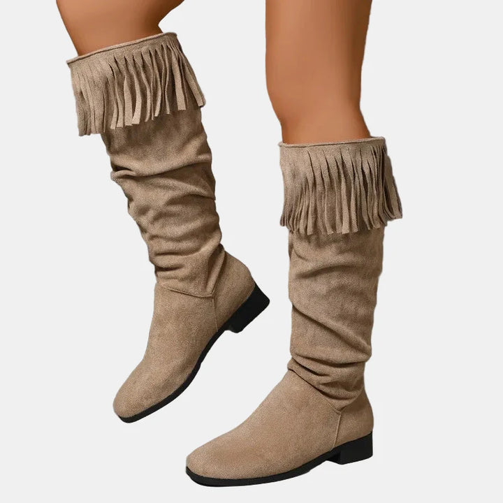 Khaki knee-high fringe boots with ruched shaft and block heel.