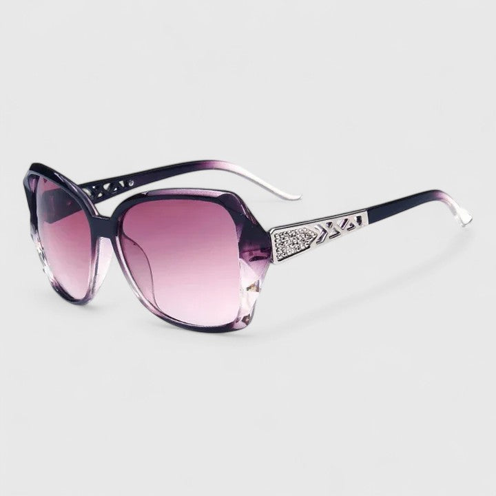 Navy and clear-accent sunglasses with purple tinted lenses and rhinestone temple detail