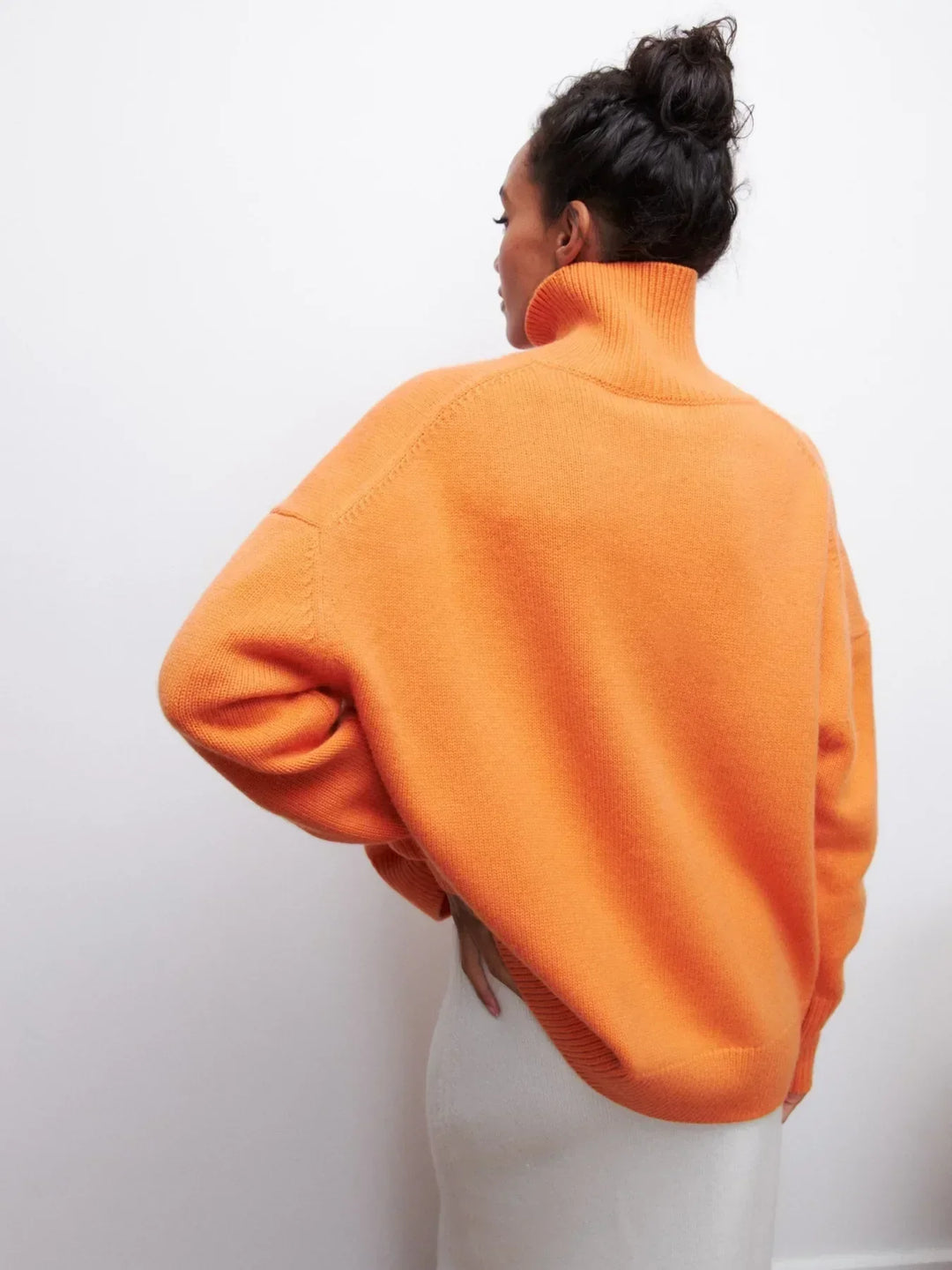 Orange turtleneck sweater, back view, ribbed collar and cuffs