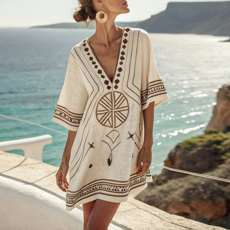 Cream beach dress with V-neck, short sleeves, and geometric embroidery border