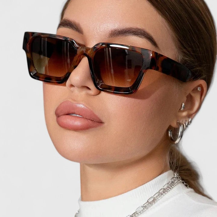 Leopard tortoiseshell sunglasses on face with dark gradient lenses