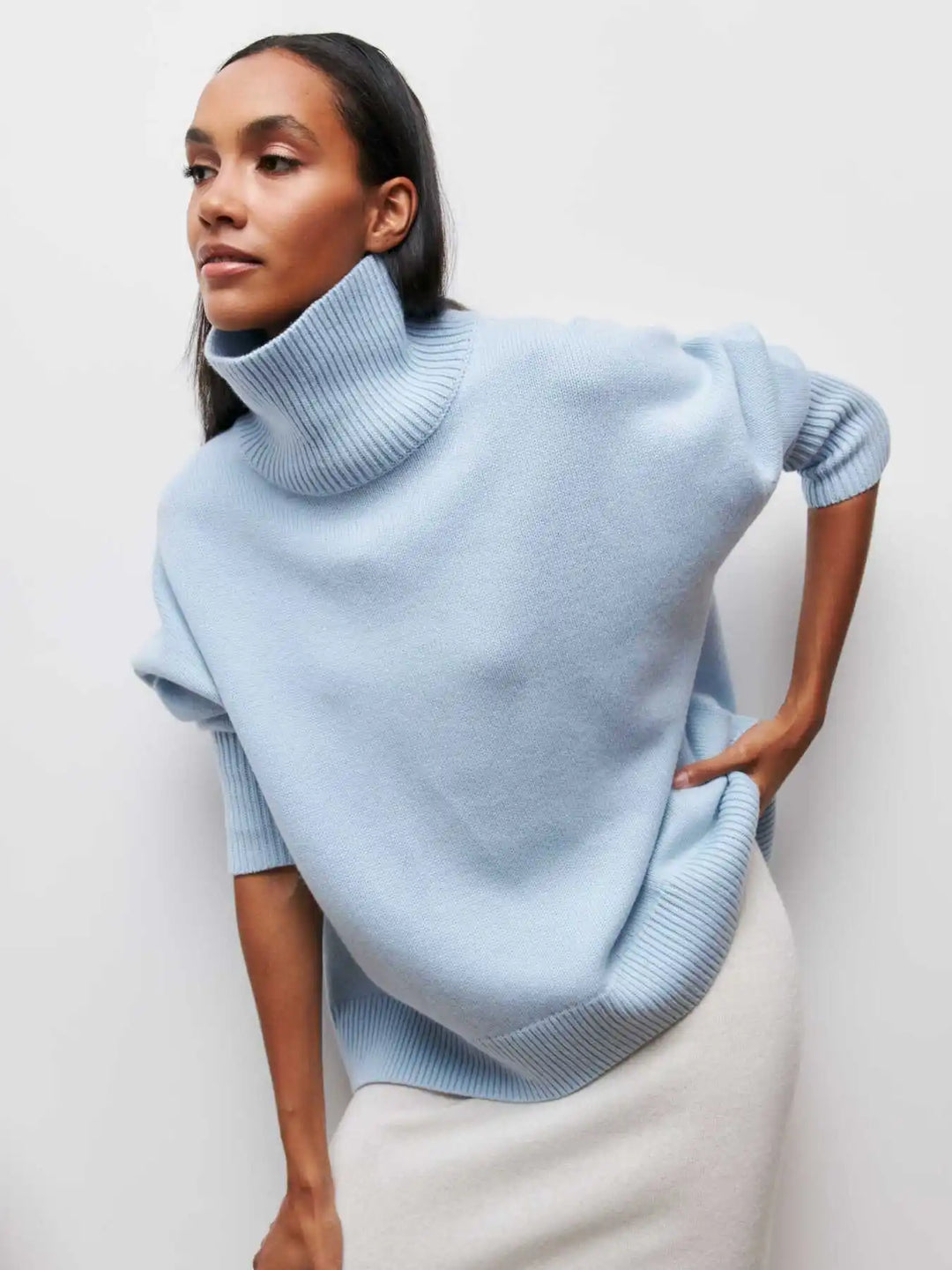 Light blue turtleneck sweater with short sleeves and ribbed neckline and hem