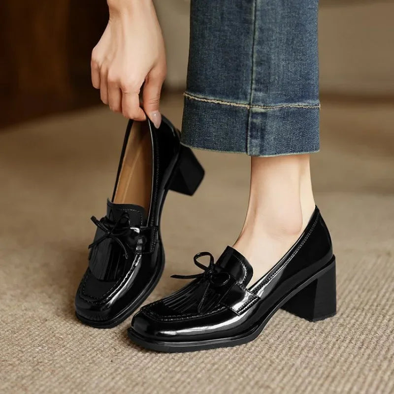 Black loafer pumps with tassel bow detail and chunky block heel