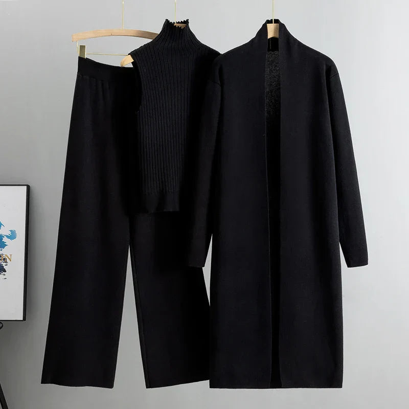 Black three-piece set: ribbed sleeveless turtleneck top, wide-leg pants, long cardigan