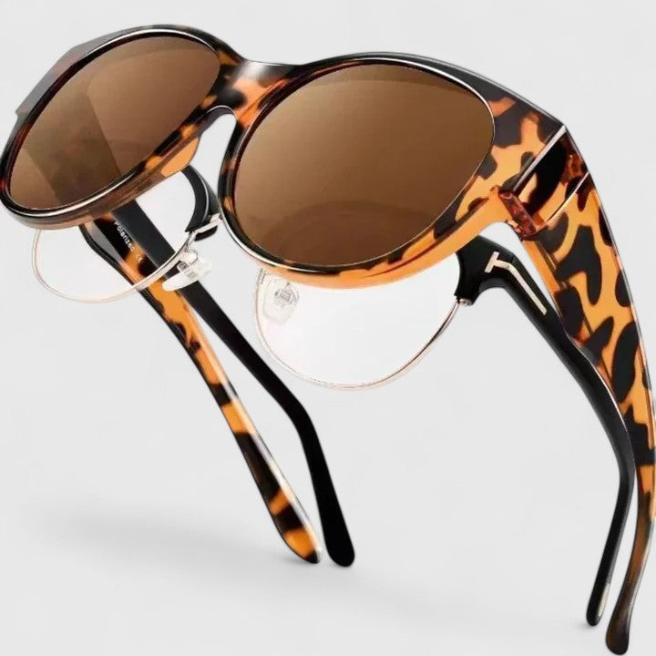 Sunglasses with tortoise-pattern frame and brown lenses, close-up detail