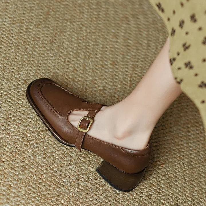 Brown T-strap loafer showing side cutout and single buckle strap