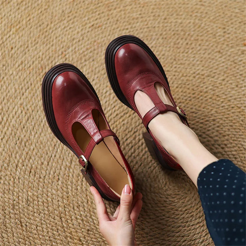 Red chunky Mary Jane pumps with ankle strap and buckle, thick black sole