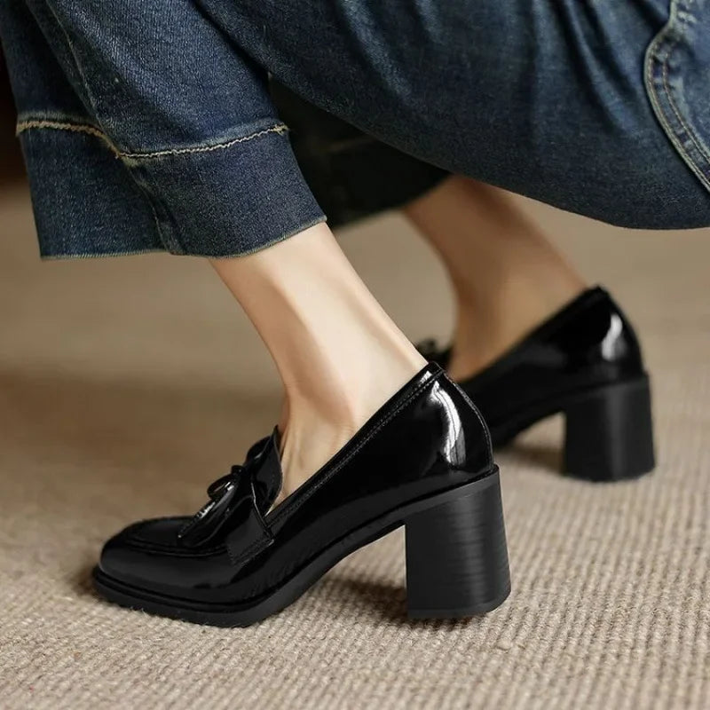 Black loafer pumps with tassel bow detail and mid block heel