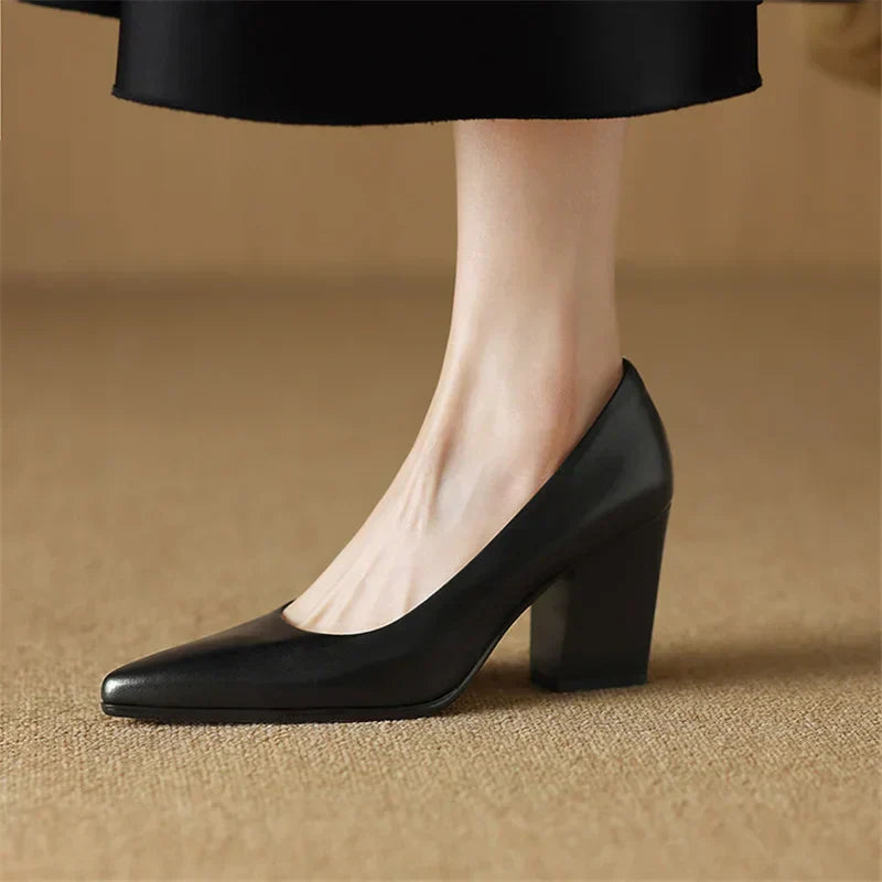 Black pointed-toe pumps with thick block heel, side angle